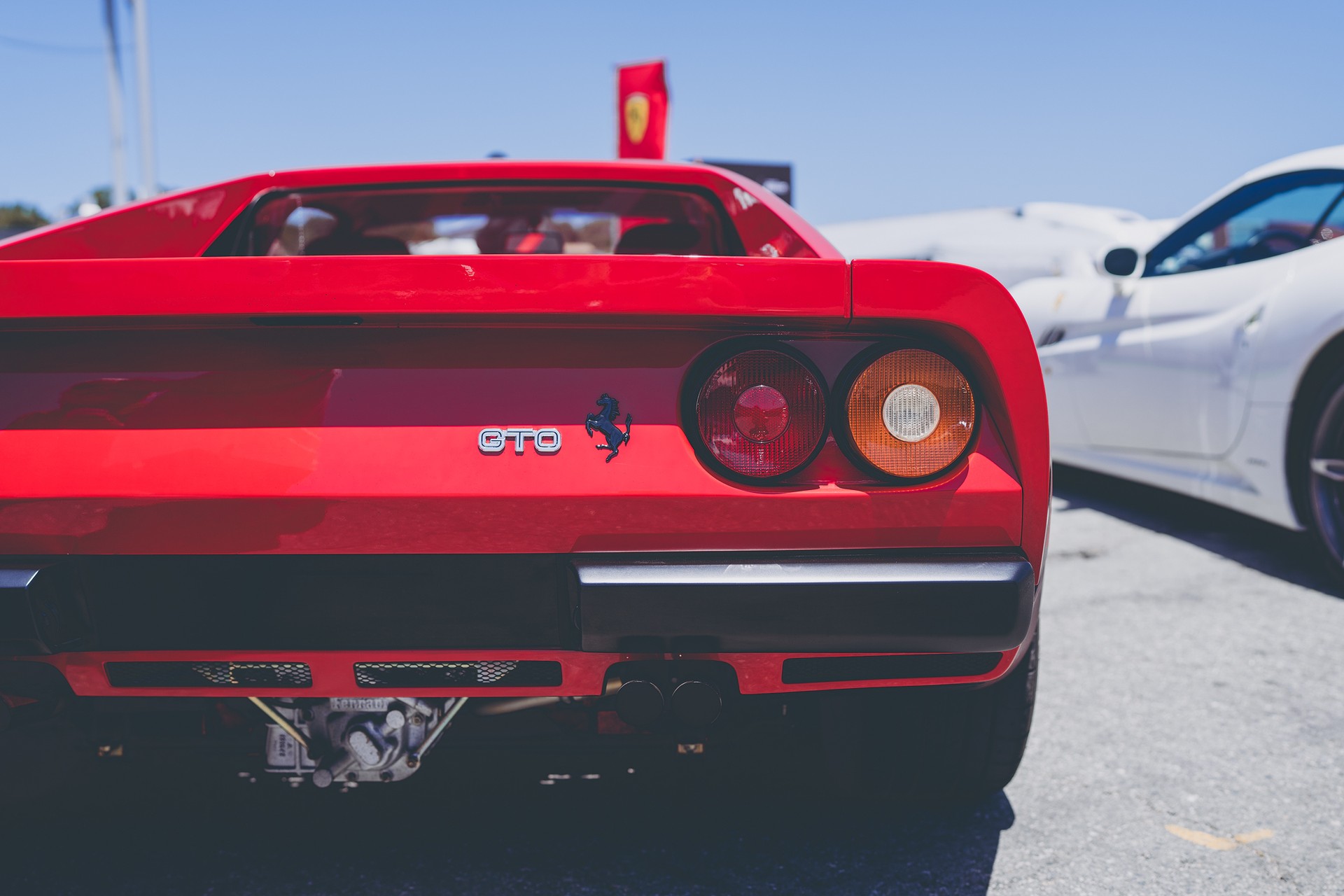 Rear detail of a red Ferrari 288 GTO, taillights and prancing horse badge